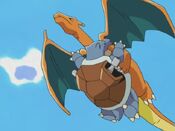 Charizard flies off, ignoring Blastoise's bite