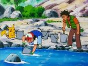 Ash and Brock carry buckets of water