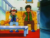 Ash and Brock watch a video of Bruno