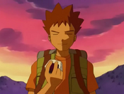 Brock holding a rice ball (known as a "Donut" in the English dub)