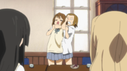 Ritsu puts Yui in a chokehold