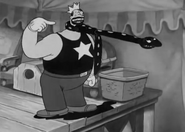 Bluto as a strongman in King of the Mardi Gras