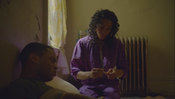 Resting on a mattress,  is checked by  on his ill health.