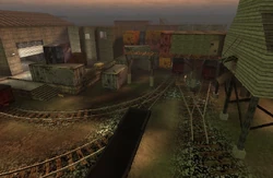 Several of the railroad switches of the trainyard. The area is surrounded by unused wagons.