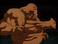 Clayface (DC Comics) in the process of smothering Batman within his own body.