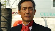 Mitsuaki Gamou (Kamen Rider Fourze) uses a Horoscopes Switch to transform into the Sagittarius Zodiarts and access Cosmic Energy.