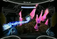 Samus Aran (Metroid Prime 3: Corruption) using the Hyper Grapple to overload a target with Phazon.