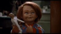 Child's Play Chucky holding a voodoo doll