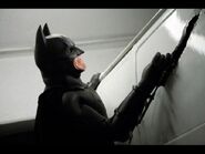 Batman (The Dark Knight) using the Pneumatic Mangler, an arm-mounted device that allows him to cut through or bend metal.