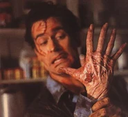 After he was bitten by the Deadite form of his girlfriend, Ash Williams' (Evil Dead) right hand was infected and possessed by them.