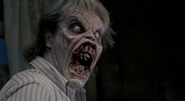 Ed (Evil Dead) has been possessed by the spirit of the Necronomicon, turning him into a Deadite.