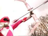 Kimberly Ann Hart/Pink Ranger (Mighty Morphin Power Rangers) pointing her Power Bow upwards.