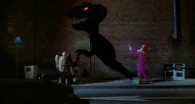 Slim (Killer Klowns from Outer Space) create shadow puppet resembling a monster that swallows people whole.