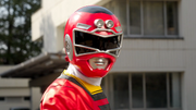 The crew's reflection on Red Racer's helmet