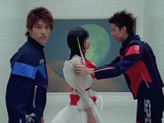 After Ban and Hoji release Erika, they place her safely behind them.