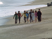 The eight Magirangers walk hand in hand at the beach