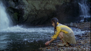 Natsuki drinks a water at the waterfall