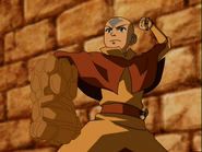 Aang (Avatar: The Last Airbender) bends the earth around to form a rock gauntlet around his arm.