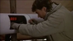 He's disarming that bomb. With a paperclip. This was the first episode.