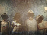 A picture frame showing four orphans with their faces concealed.