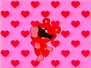 Bobby BearHug, with hearts in the background.