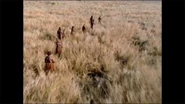 A tribe of Aboriginal Australians traveling across the Australian outback.