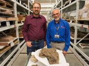 Randy Irmis, Utah Museum of Natural History paleontology curator and volunteer Randy Johnson, stand by the skull of an ankylosaurid dinosaur called the Akainacephalus johnsoni.