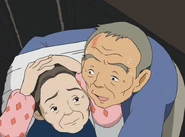 The grandfather protects his wife from the fallen drawer.