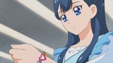 Saaya looks at her bracelet