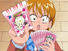 Nagisa frustratingly picks the Omp card, after a few mistaken attempts.