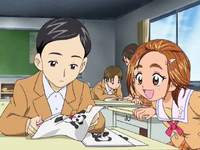 Manabu helping Saki cut out the dolls