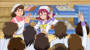 Mana, along with the baker, serving the students in the bakery.