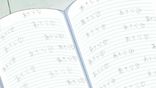 Ichika's notebook with Akira's name written over and over again