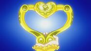 The Heart Baton in its golden form. In the first Pretty Cure movie, Pretty Cure and Shiny Luminous are given power-ups when given the charms of the Courageous Warriors, making them appear golden, as well as the Heart Baton.