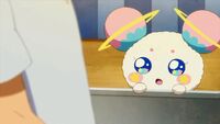 Fuwa watches the man make cotton candy