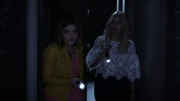 Aria and Hanna walk down a hallway at night at The Radley