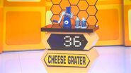 He bids $25 on the hand-crank grater. A difference of $11. He gets no card.