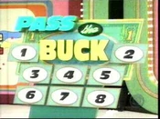 The original Pass the Buck game board from early playings using 8 numbers. Note that 1 and 2 are placed on the left and right sides of the board, while 3-8 are underneath. This setup lasted for only 11 playings.