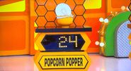 She bids $35 on the Opopop silicone popcorn popper. A difference of $11. She gets no card.