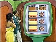 ...for a total of $105. She keeps the cookware, leather set, and flatware no matter what. But if they total $105 or more, she wins the sailboat.