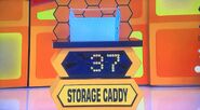 She bids $20 on the storage caddy. A difference of $17. She gets no card.
