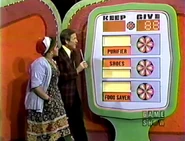 She keeps the food saver, shoes, and purifier no matter what happens. But if they total $88 or more, she wins the living room group.