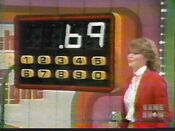 The contestant guesses 69 cents for one of the grocery items as Holly punched it out on the calculator