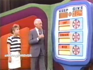 ...for a total of $124. She keeps the mixer, cookware, and knife no matter what. But if they total $124 or more, she wins the dinnerware and living room group.