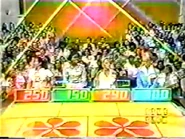 Contestant's Row from 1975: Shortly before the show debuted to one hour, the seat covers were changed to blue and have been updated to reflect the show's current name. Notice the second podium is green and the fourth podium is blue.