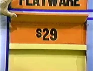 The leather set is $29 and goes into the keep column for a total for a total of $54 thus far. If the flatware is $51 or more, she wins.