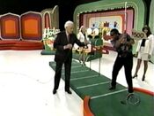 And Anita's so anxious to putt the ball, she accidentally swings the putter towards Bob, so he backs off! No wonder!