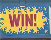 The ultra-cool win tag, from 1988. The letters are in purple. The spark is yellow and the background is blue.