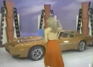 Arrive to a football game in a Pontiac Trans Am.