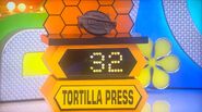 She bids $30 on the Uno Casa tortilla press. A difference of $2. She picks card #4.